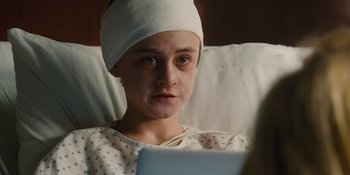 Movie still from “The Book of Henry” (2017), directed by Colin Trevorrow – A young person wearing a head band in a hospital bed; Close Up shot, Over the shoulder angle