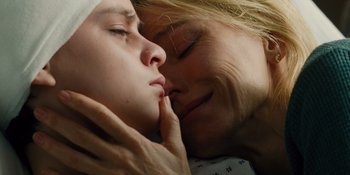 Movie still from “The Book of Henry” (2017), directed by Colin Trevorrow – A person kissing another person on the cheek; Close Up shot, Overhead angle