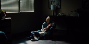 Movie still from “The Book of Henry” (2017), directed by Colin Trevorrow – A woman sitting on the ground with a child; Wide shot, High angle