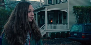 Movie still from “The Book of Henry” (2017), directed by Colin Trevorrow – A young girl standing in front of a house; Close Up shot, Over the shoulder angle