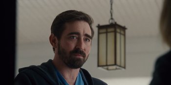 Movie still from “The Book of Henry” (2017), directed by Colin Trevorrow – A person with a beard looking at the camera; Close Up shot, Over the shoulder angle