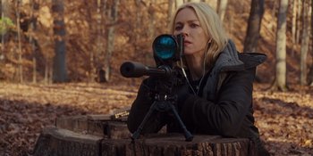 Movie still from “The Book of Henry” (2017), directed by Colin Trevorrow – A woman is holding a rifle and looking at the camera; Medium shot, Over the shoulder angle