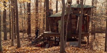 Movie still from “The Book of Henry” (2017), directed by Colin Trevorrow – A person standing on a platform in the woods; Extreme Wide shot, High angle