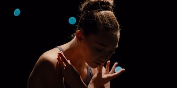 Movie still from “The Book of Henry” (2017), directed by Colin Trevorrow – A young woman with her hands in the air in front of her face; Close Up shot, High angle