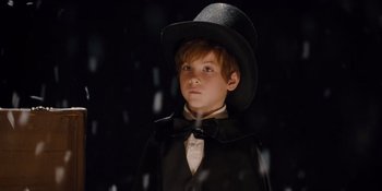 Movie still from “The Book of Henry” (2017), directed by Colin Trevorrow – A young boy wearing a top hat and a bow tie; Close Up shot, Low angle