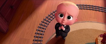 Movie still from “The Boss Baby” (2017), directed by Tom McGrath – A cartoon of a little boy in a suit and tie next to train tracks; Medium shot, High angle