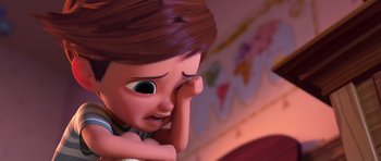 Movie still from “The Boss Baby” (2017), directed by Tom McGrath – A cartoon character's face with one hand on his face; Close Up shot, Over the shoulder angle