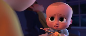 Movie still from “The Boss Baby” (2017), directed by Tom McGrath – The boss baby eating noodles with chopsticks in his hands; Close Up shot, High angle