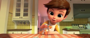Movie still from “The Boss Baby” (2017), directed by Tom McGrath – A cartoon boy with a jar of orange juice on a table; Medium shot, High angle