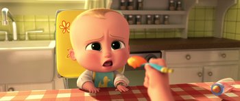 Movie still from “The Boss Baby” (2017), directed by Tom McGrath – A person is feeding a baby from a spoon; Close Up shot, Over the shoulder angle