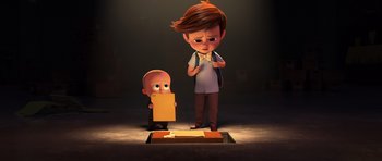 Movie still from “The Boss Baby” (2017), directed by Tom McGrath – A boy and a boy are standing in front of a paper; Medium shot, High angle