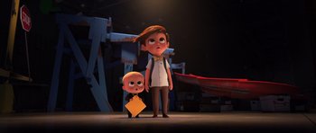 Movie still from “The Boss Baby” (2017), directed by Tom McGrath – A boy and a girl standing next to each other on a stage; Wide shot, High angle