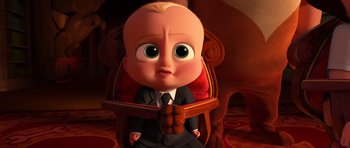 Movie still from “The Boss Baby” (2017), directed by Tom McGrath – The boss baby sitting in a chair with his hands on his chest; Medium shot, High angle