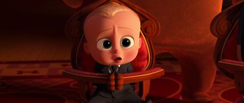 Movie still from “The Boss Baby” (2017), directed by Tom McGrath – The boss baby sitting in a chair with his hands folded in front of his face; Medium shot, High angle