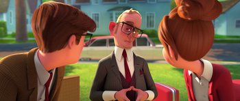 Movie still from “The Boss Baby” (2017), directed by Tom McGrath – A man in a suit and tie talking to two other people; Medium shot, Over the shoulder angle