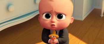 Movie still from “The Boss Baby” (2017), directed by Tom McGrath – A baby is holding a small toy in his hands; Close Up shot, High angle