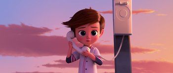 Movie still from “The Boss Baby” (2017), directed by Tom McGrath – A cartoon boy holding a phone up to his ear; Medium shot, Low angle