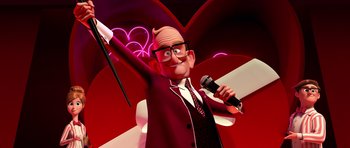 Movie still from “The Boss Baby” (2017), directed by Tom McGrath – An animated man holding a microphone and a microphone stand in front of a pink background; Medium shot, Low angle