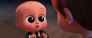 Movie still from “The Boss Baby” (2017), directed by Tom McGrath – A cartoon baby looking at another cartoon character in a suit; Medium shot, High angle