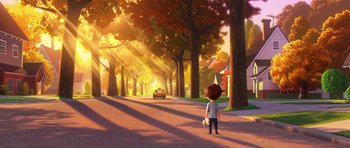 Movie still from “The Boss Baby” (2017), directed by Tom McGrath – A boy standing on the side of a road near trees; Extreme Wide shot, Low angle