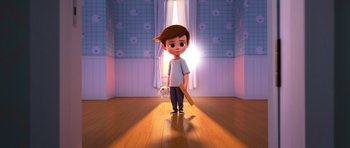 Movie still from “The Boss Baby” (2017), directed by Tom McGrath – A boy standing on a wooden floor holding a baseball bat; Wide shot, High angle