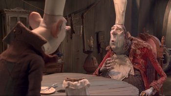 Movie still from “The Boxtrolls” (2014), directed by Anthony Stacchi – A person in a chef's outfit sitting in front of a table; Medium shot, Over the shoulder angle