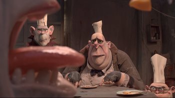 Movie still from “The Boxtrolls” (2014), directed by Anthony Stacchi – A man sitting at a table wearing a chef's hat; Medium shot, Over the shoulder angle