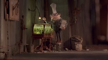 Movie still from “The Boxtrolls” (2014), directed by Anthony Stacchi – An animated character is standing in front of a fish tank; Wide shot, Low angle