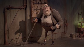 Movie still from “The Boxtrolls” (2014), directed by Anthony Stacchi – A man with a large head is holding a broom; Wide shot, Low angle