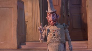 Movie still from “The Boxtrolls” (2014), directed by Anthony Stacchi – A man in a suit and hat standing in front of a building; Medium shot, Low angle