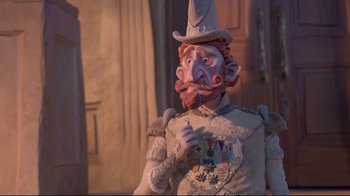 Movie still from “The Boxtrolls” (2014), directed by Anthony Stacchi – A statue of a man in a suit and a hat; Medium shot, Low angle