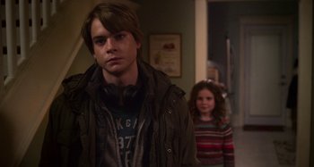 Movie still from “The Christmas Chronicles” (2018), directed by Clay Kaytis – A man and a little girl standing in front of a door; Medium shot, Over the shoulder angle