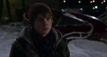 Movie still from “The Christmas Chronicles” (2018), directed by Clay Kaytis – A young man wearing a hat and a scarf; Close Up shot, Over the shoulder angle
