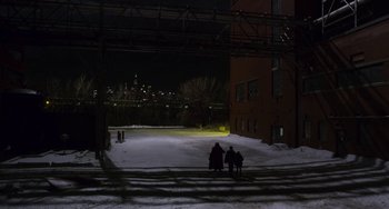 Movie still from “The Christmas Chronicles” (2018), directed by Clay Kaytis – A group of people standing in the snow near a building; Extreme Wide shot, High angle