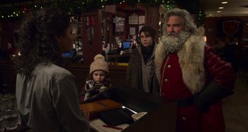 Movie still from “The Christmas Chronicles” (2018), directed by Clay Kaytis – A group of people standing next to each other in a room; Medium shot, Over the shoulder angle