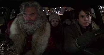 Movie still from “The Christmas Chronicles” (2018), directed by Clay Kaytis – A man and a child in the back seat of a car; Close Up shot, Over the shoulder angle
