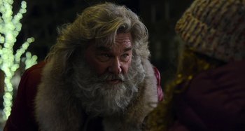 Movie still from “The Christmas Chronicles” (2018), directed by Clay Kaytis – An old man with a long beard wearing a fur coat; Close Up shot, Over the shoulder angle