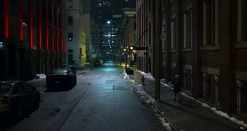 Movie still from “The Christmas Chronicles” (2018), directed by Clay Kaytis – A city street at night lit by street lights; Extreme Wide shot, High angle