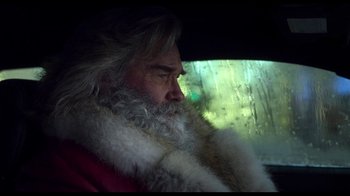 Movie still from “The Christmas Chronicles” (2018), directed by Clay Kaytis – A man with long white beard sitting in a car; Close Up shot, Low angle