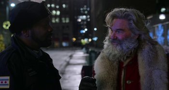 Movie still from “The Christmas Chronicles” (2018), directed by Clay Kaytis – A man with a long beard talking to another man; Close Up shot, Over the shoulder angle