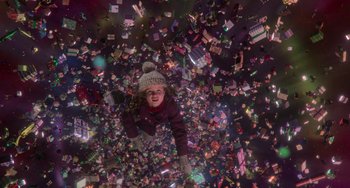 Movie still from “The Christmas Chronicles” (2018), directed by Clay Kaytis – A girl is laying on the ground surrounded by lots of toys; Extreme Wide shot, Overhead angle