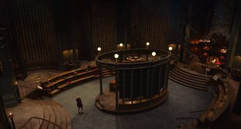 Movie still from “The Christmas Chronicles” (2018), directed by Clay Kaytis – A person standing in front of a large round building; Extreme Wide shot, High angle