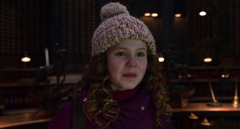 Movie still from “The Christmas Chronicles” (2018), directed by Clay Kaytis – A young girl wearing a knitted hat with a pom - pom; Close Up shot, Over the shoulder angle