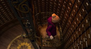 Movie still from “The Christmas Chronicles” (2018), directed by Clay Kaytis – A person wearing a purple jacket and a knitted hat is climbing a ladder; Wide shot, Overhead angle