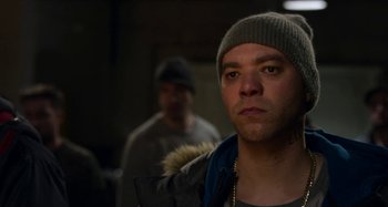 Movie still from “The Christmas Chronicles” (2018), directed by Clay Kaytis – A man in a hat and jacket looking at the camera; Close Up shot, Over the shoulder angle