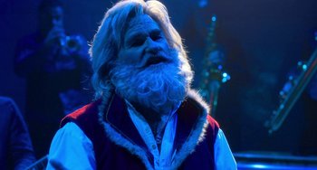Movie still from “The Christmas Chronicles” (2018), directed by Clay Kaytis – A man with long white hair and a white beard; Close Up shot, Over the shoulder angle
