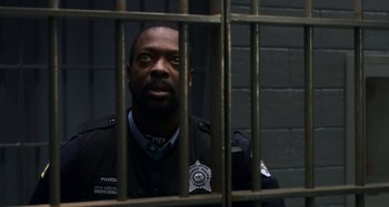 Movie still from “The Christmas Chronicles” (2018), directed by Clay Kaytis – A man that is in a jail cell; Close Up shot, High angle