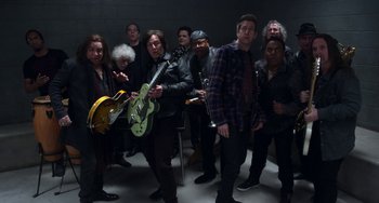 Movie still from “The Christmas Chronicles” (2018), directed by Clay Kaytis – A group of people that are standing up in a room; Wide shot, High angle