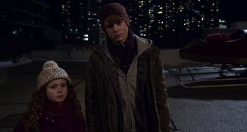 Movie still from “The Christmas Chronicles” (2018), directed by Clay Kaytis – A boy and a little girl standing next to each other; Medium shot, Over the shoulder angle