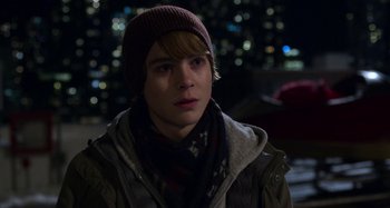 Movie still from “The Christmas Chronicles” (2018), directed by Clay Kaytis – A young man wearing a hat and a scarf; Close Up shot, Over the shoulder angle